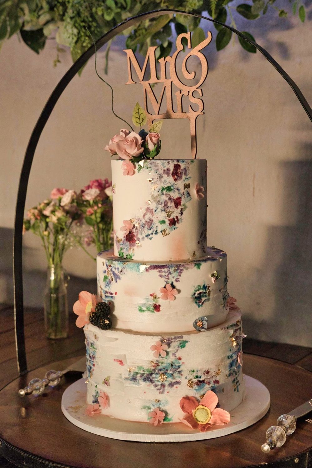 White wedding cake with colourful fresh florals